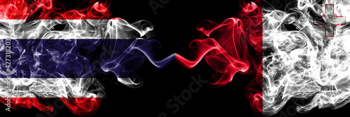 Thailand, Thai vs Malta, Maltese smoky mystic flags placed side by side. Thick colored silky abstract smokes flags.
