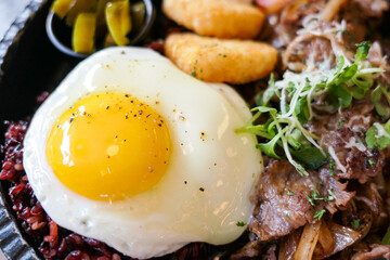 brunch plating with sunny side up fried egg