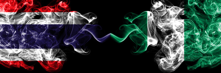 Thailand, Thai vs Nigeria, Nigerian smoky mystic flags placed side by side. Thick colored silky abstract smokes flags.