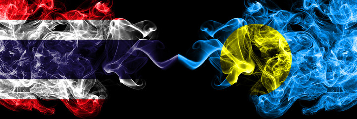 Thailand, Thai vs Palau smoky mystic flags placed side by side. Thick colored silky abstract smokes flags.