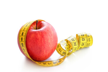 Red apple with measuring tape isolated on white background. Healthy lifestyle, diet concept
