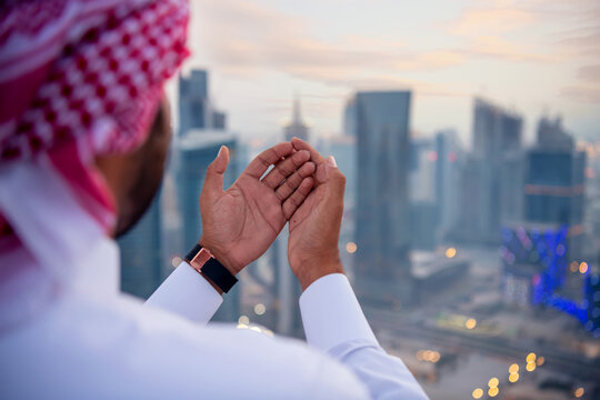 Arab Man Prying Hand at sunset time. Ramzan Greeting concept. No Face 