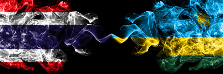 Thailand, Thai vs Rwanda smoky mystic flags placed side by side. Thick colored silky abstract smokes flags.