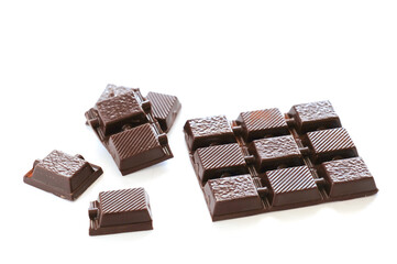 Milk chocolate pieces isolated on white background. Side view
