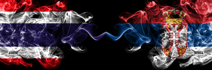 Thailand, Thai vs Serbia, Serbian smoky mystic flags placed side by side. Thick colored silky abstract smokes flags.