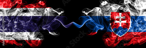 Thailand, Thai vs Slovakia, Slovakian smoky mystic flags placed side by side. Thick colored silky abstract smokes flags.