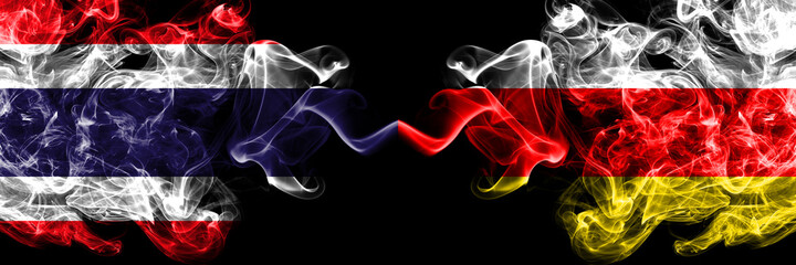 Thailand, Thai vs South Ossetia smoky mystic flags placed side by side. Thick colored silky abstract smokes flags.