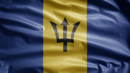 Barbadian flag waving in the wind. Close up of Barbados banner blowing soft silk