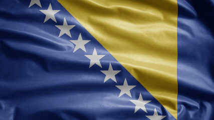 Bosnian flag waving in the wind. Close up of Bosnia banner blowing, soft silk.