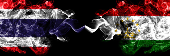 Thailand, Thai vs Tajikistan smoky mystic flags placed side by side. Thick colored silky abstract smokes flags.