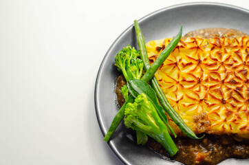 Tender minced lamb with garden veg in a hearty gravy beneath butter mash, typical Shepherd's pie