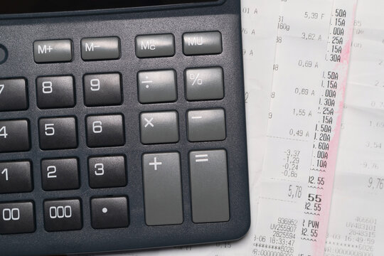 Calculator and checks, symbolize income and expense planning