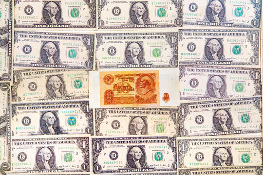 Top view of the dollar bills and rubles of the Soviet Union, made as a background. The texture of American dollars