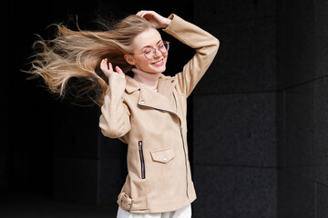 Model blonde with long hair in strong wind for a walk