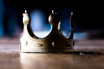 Toy plastic crown in bad shape. Corruption, power struggle, worn out monarchies. 