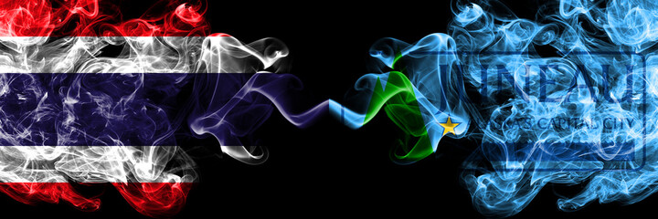 Thailand, Thai vs United States of America, America, US, USA, American, Juneau, Alaska smoky mystic flags placed side by side. Thick colored silky abstract smokes flags.