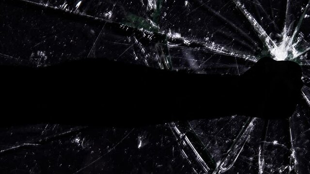 A male arm (silhouetted) hitting a malfunctioning tv screen, cracking it and creating a hole in the glass. Visual metaphor: the bad way to fix things.
