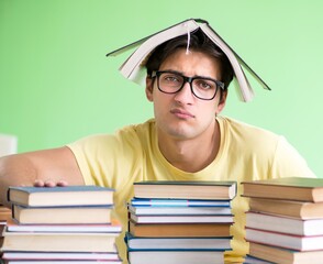 Student with too many books to read before exam