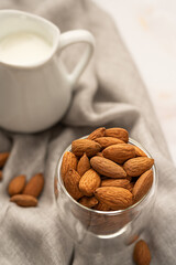 Vegan almond milk in jug and almond. Non dairy alternative milk.