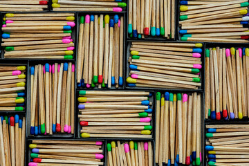 Obraz premium multicolored match sticks in boxes on a black background