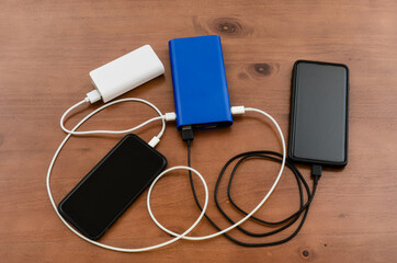 Charge sharing: recharging two cellphones combining two power banks