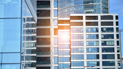 Glass clad facade of a modern building covered in reflective plate glass.