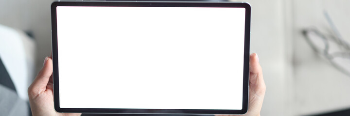 In female hands tablet with white screen.