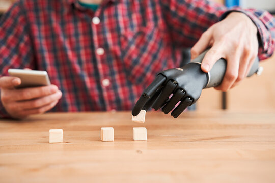 Engineer Taking A Little Cubes With The Bionic Hand While Testing Functionality