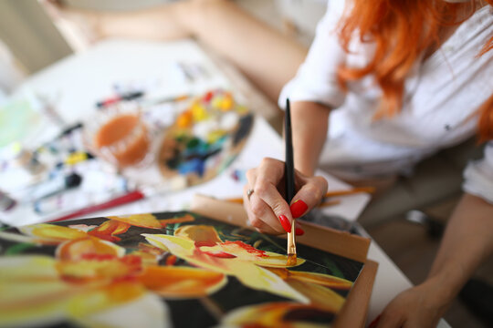 Top view of beautiful woman creating masterpiece in studio