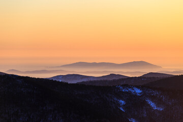Travel across the Primorsky Territory. View of the valley from the top of the mountain during a golden sunset.
