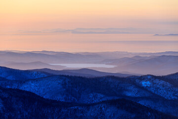 Travel across the Primorsky Territory. View of the valley from the top of the mountain during a golden sunset.