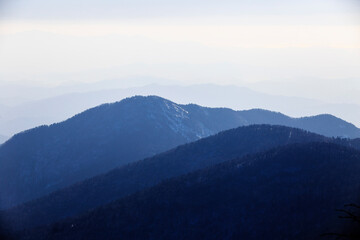 Obraz premium Travel to the Primorsky region. Silhouettes of distant snowy mountains. Mountain tourism.