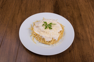 Tasty pasta with bechamel sauce with grated cheese and parsley leaves. Typical food from Italy and France. Macaroni Popular in Brazil.