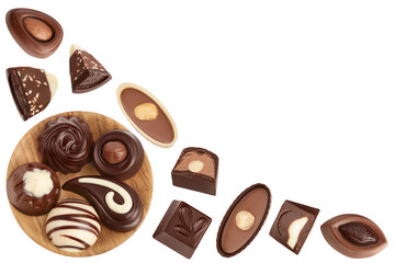 Chocolate candy in wooden bowl isolated on white background. Top view with copy space for your text. Flat lay