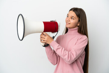 Little girl over isolated white background shouting through a megaphone to announce something