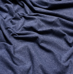 Naklejka na ściany i meble wrinkled blue cotton fabric for sewing t-shirts and clothing