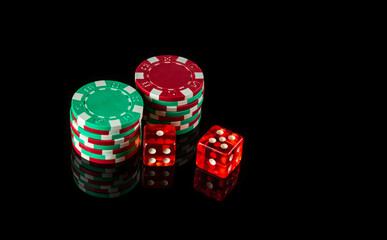 Poker dice on black table and chips in the background. Craps club game concept