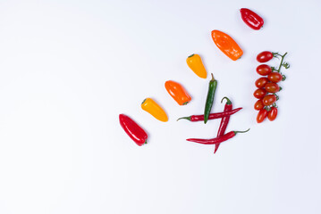 presentation of multicolored peppers, avocado on white backgrounds