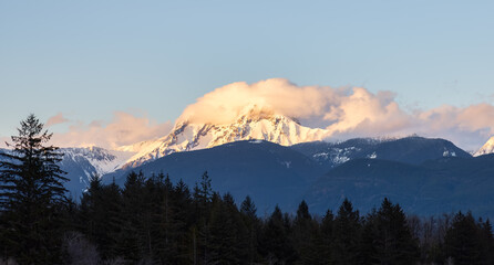 Panoramic View of Canadian Mountain Landscape covered in Clouds. Colorful Sunset Sky. Mt Garibaldi in Squamish, British Columbia, Canada. Nature Background Panorama
