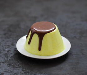 Jelly lemon with chocolate on a plate on a dark gray background