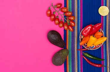 presentation of multicolored peppers, avocado guacamole on pink and backgrounds