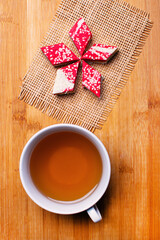 Pomegranate halva dessert slices on the table with a cup of tea.