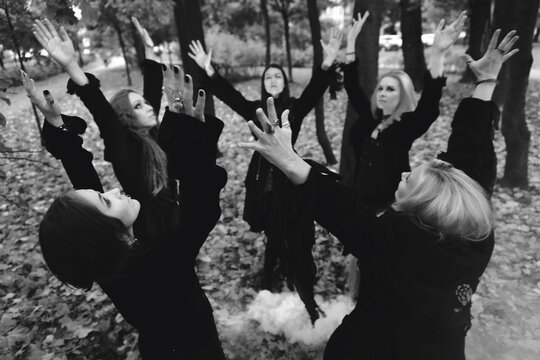 Coven of witches, a group of friends as witches on Halloween perform a ritual, lead a round dance and recite spells.