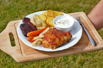 Roasted chicken leg with grilled vegetables potato, carrot, beetroot, onion