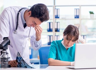 Two doctors discussing x-ray MRI image in hospital