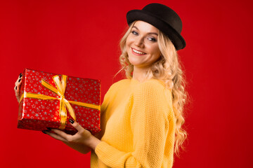 Winter holiday, a young woman in knitted clothes and a bowler hat