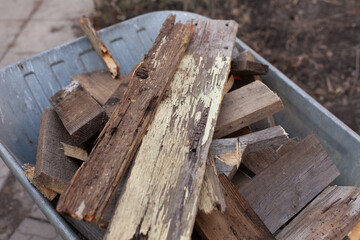 Old wooden planks laying in a wheelbarrow
