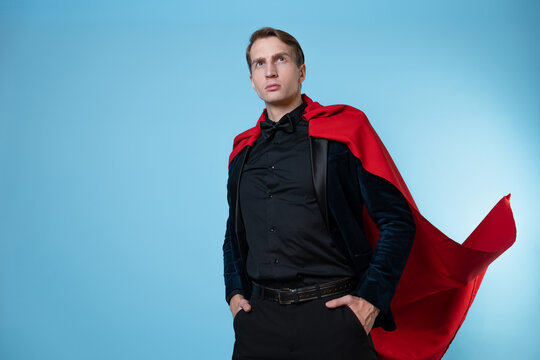 Businessman in a suit with a red cape in the image of a superhero, strong and confident,