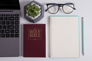 Top view of the bible, laptop and glasses. Online Bible Study Concept During Quarantine
