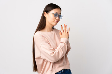 Young Chinese girl over isolated white background scheming something